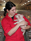 Person holding piglet.